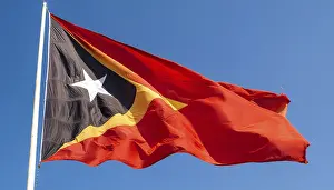 Blue Skies With Flags Prints: The flag of Timor, fluttering in the wind