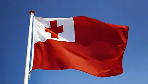 Prints of The flag of Tonga, fluttering in the wind, isolated, against the blue sky Tonga Prints: The Flag of Tonga Print - Blue Sky Background