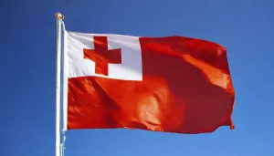Prints of The flag of Tonga, fluttering in the wind, isolated, against the blue sky Tonga Prints: The Flag of Tonga Print: Blue Sky Scene