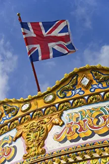 Union Jack Flag Design Prints: Flag of the United Kingdom above a carousel on the pier in Brighton