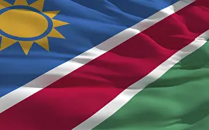 Empty Desert Landscapes Prints: Fluttering flag of Namibia on the wind