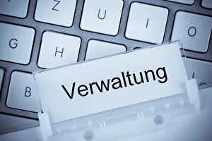 German Politics Prints: The folder of a hanging file in front of a computer keyboard on the subject of administration Studio recording