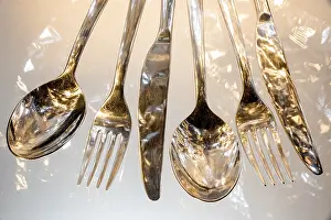Uninhabited Dining Table Scene Prints: Fork, spoon and knife with reflections and light effects
