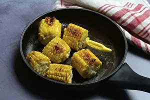 Sweet Corn Nutrition Facts Prints: Fried corn on the corn cob in pan