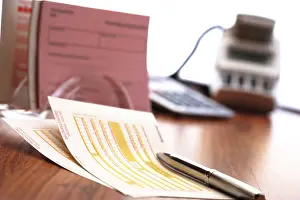 Cashless Payment Prints: Funds transfer form and a pen, more forms in background