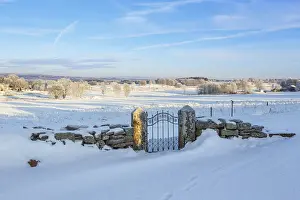 European Frosty Landscape Prints: Gate at a stone wall covered with snow