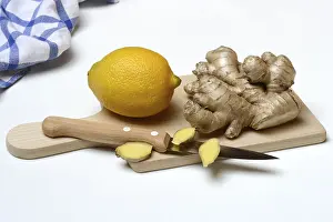 Ginger Root Prints: Ginger root and lemon on kitchen board with knife