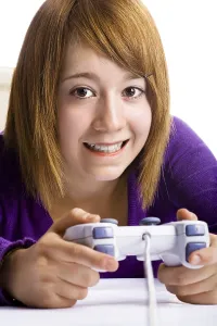 Girl Gamer Prints: Girl with a game controller playing a computer game