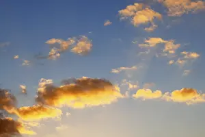 Evening Sun In Germany Prints: Glowing clouds in the evening sky at sunset
