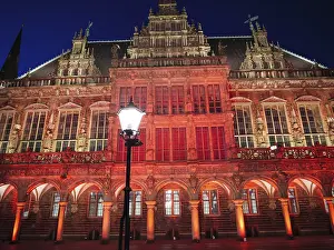 Prints of Gothic architecture in red lighting, building illuminated at night with central lantern, Bremen, Germany Bremen Prints: Gothic Architecture Print - Bremen, Germany at Night