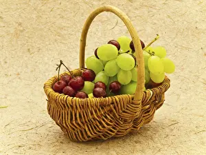 Wine Grape Images Prints: Grape And Cherry In Basket Over The Beige Background