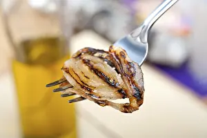 Gastronomy Meal Ideas Prints: Grilled onion on a fork macro close up