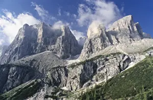 Uninhabited Mountain Peaks Prints: Group of jagged mountains rand thin clouds