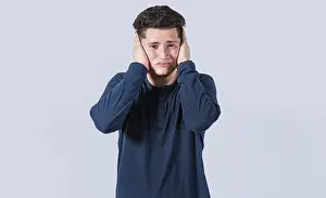 Man Covering Ears Prints: A guy covering his ears, avoiding hearing