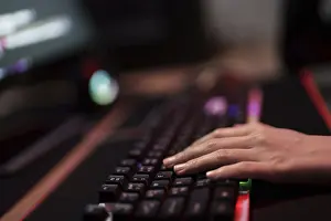 Digital Information Security Prints: Hacker in dark room using keyboard stealing data on internet