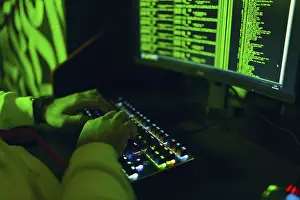 Computer Virus Protection Prints: Hacker in hoodie working hacks code site on personal computer