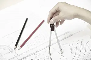 Construction Plan Prints: Hand of engineer working on a construction plan