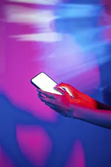 Modern Technology Concept Prints: A hand interacts with a smartphone