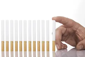 Smoking Addiction Prints: Hand beside a row of cigarettes