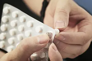 Blister Packaging Prints: Hands taking out a tablet from a blister pack