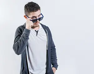 Latin American Male Model Prints: Handsome guy lowering his glasses looking at the camera
