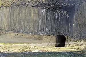 Basalt Cliffs Scotland Prints: High basalt cliffs with a small cave on the coast