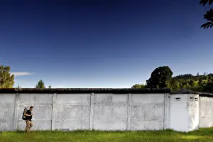 Inner German Border Prints: Hiker in front of border wall, man with backpack
