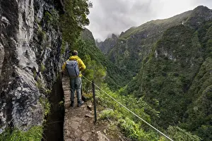 Eroded Landscape Photo Prints: Hikers on a narrow path along a levada