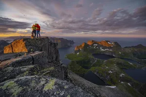 Hiking In Norway Prints: Two hikers at the summit, sunset with dramatic clouds
