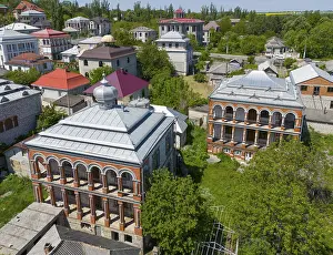 Prints of Two historic buildings in a green area, surrounded by trees and with red roofs, aerial view, Soroca, district with imposing villas of the Roma minority, Gypsy quarter, Gypsy capital of Moldova Moldova Prints: Two Historic Buildings in Soroca Print, Moldova