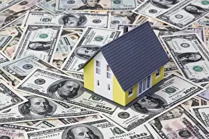 US Dollar Note Value Prints: A house stands on many dollar notes