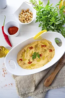 Hummus With Lemon And Chilli Prints: Hummus paste with lemon and chilli on a white background