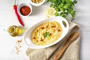 Arabic Food Photography Prints: Hummus paste with lemon and chilli on a white background