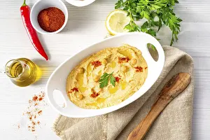 Arabic Food Photography Prints: Hummus paste with lemon and chilli on a white background