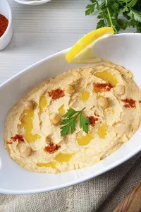 Lemon Hummus Prints: Hummus paste with lemon and chilli on a white background