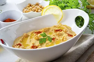 Lemon Hummus Prints: Hummus paste with lemon and chilli on a white background