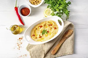 Hummus With Lemon And Chilli Prints: Hummus paste with lemon and chilli on a white background