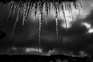 Dark Sky Germany Prints: Icicle on gutter in front of dark sky