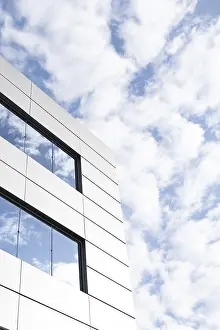 Minimalist Modern Architecture Prints: An image capturing a segment of a modern building's exterior featuring angular white panels