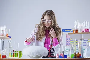 Little Girl Scientist Prints: Image of cute student watching over experiment in lab