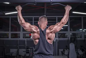 Healthy Lifestyle Image Prints: Image of a powerful athlete doing a pull-up in the gym