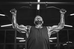 Weight Training Routine Prints: Image of a powerful athlete doing a pull-up in the gym