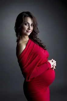 Expectant Mother Prints: Image of smiling expectant mother posing at camera
