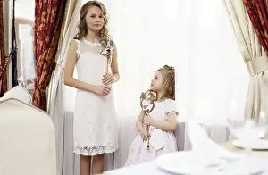 Sisters Looking At Camera Prints: Image of two young nice sisters posing at camera