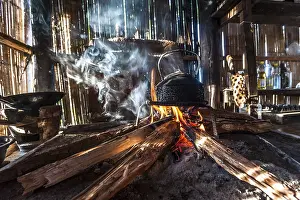 Southeast Asia Culture Prints: Kettle over an open fire in a kitchen made of bamboo
