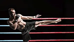 Fitness Model Male Prints: Kickboxer posing in the ring. Middle Kick