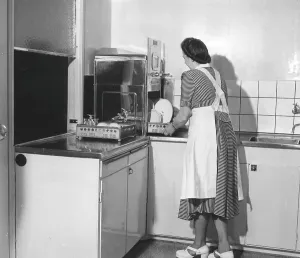 1950s Kitchen Scene Print - Woman Using a Stainless Steel Dishwasher