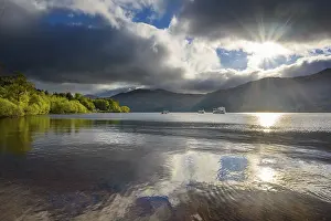 United Kingdom Travel Images Prints: Lake with dramatic clouds and sun in spring