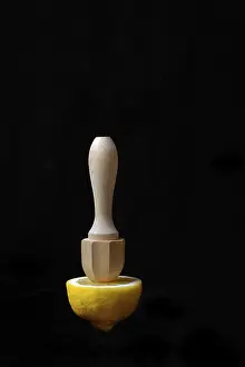 Black Background Still Life Prints: Lemon and lemon squeezer against a black background
