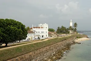 Deserted Asian Beaches Prints: Lighthouse on the seafront with a long wall